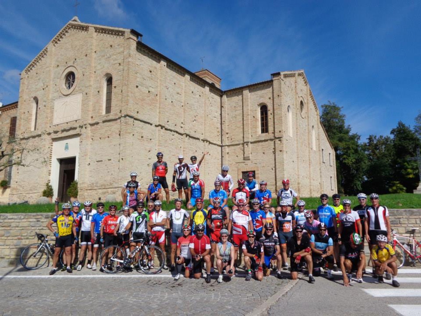 The Cycling Journeys community in front of an Italian abbey